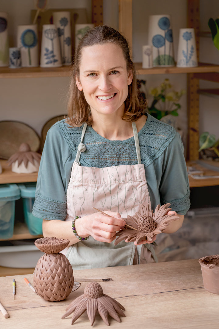 Emma sculpting clay to make sea holly garden ornament