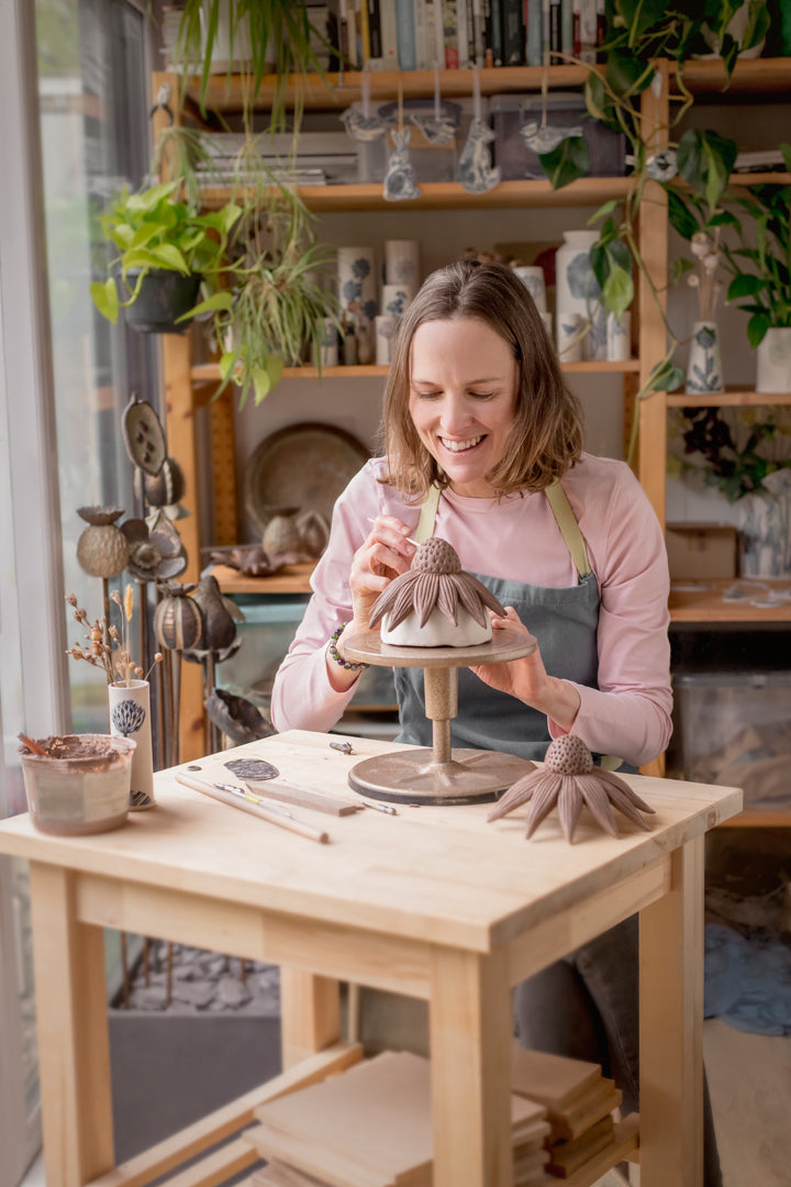 Emma Working in the studio making Echinacea garden ornaments out of clay.