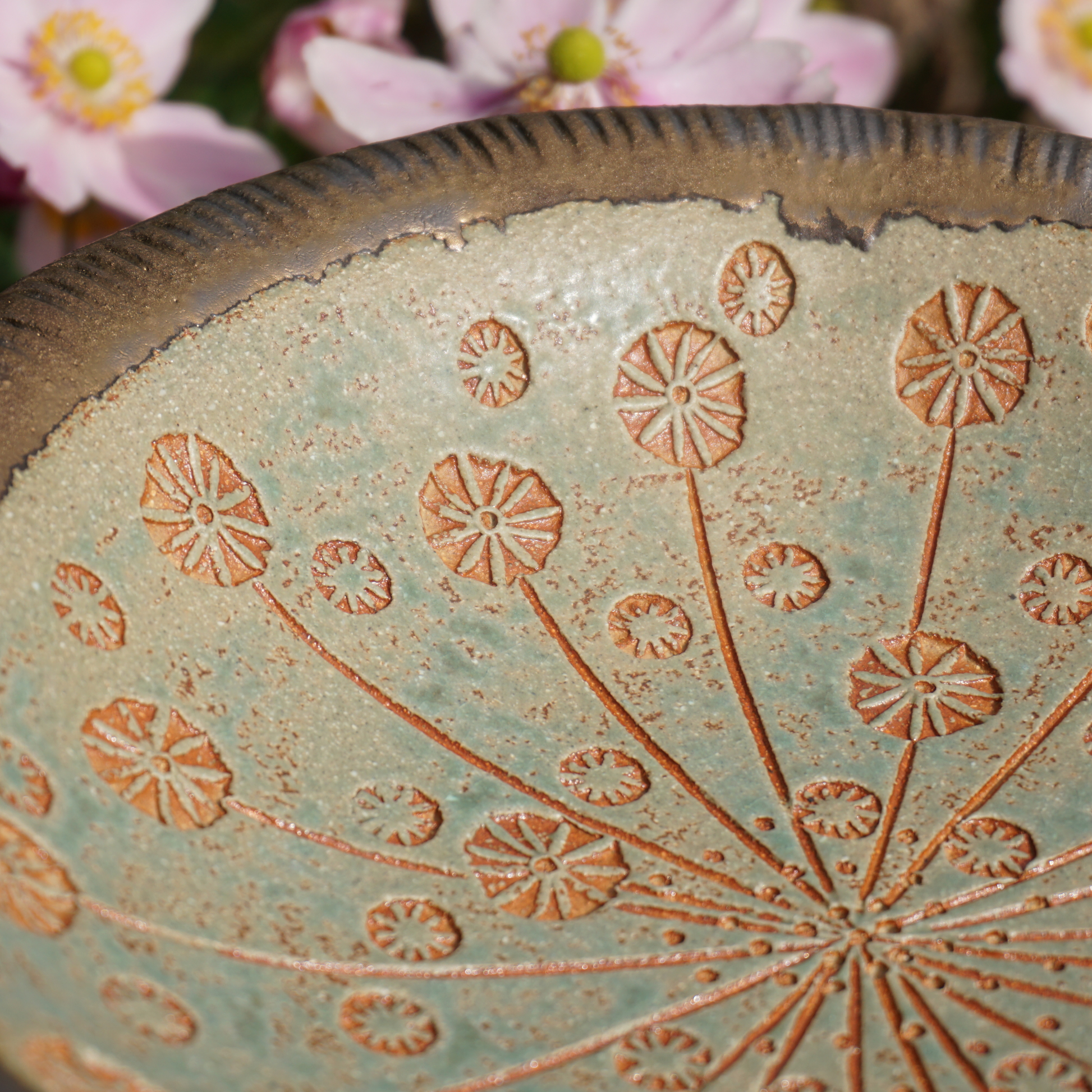 close up of stamped impressions in cow parsley bird bath