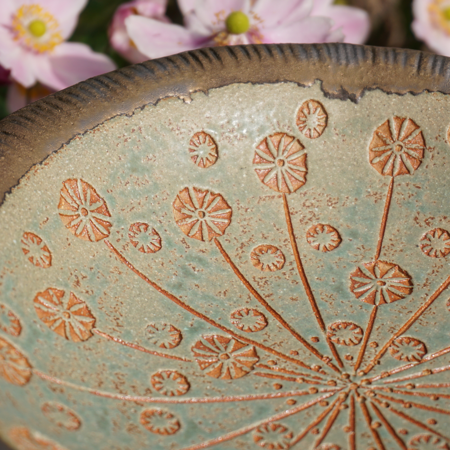 close up of stamped impressions in cow parsley bird bath