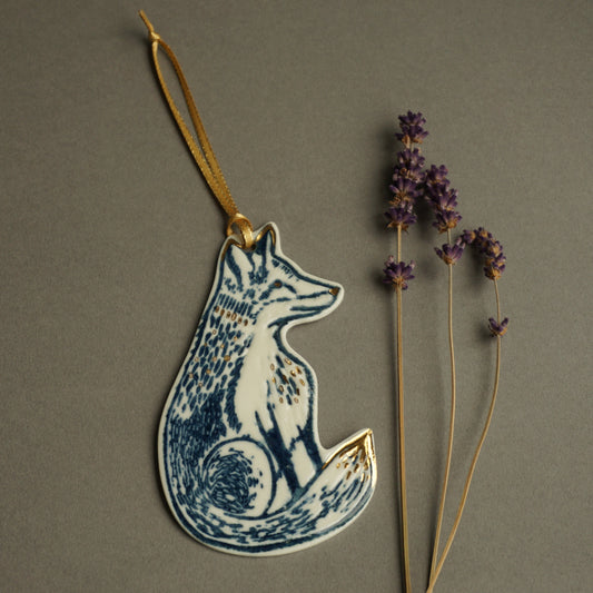 Porcelain Fox hanging decoration with gold lustre and gold ribbon, impressed with a hand carved lino cut to create the textured details.